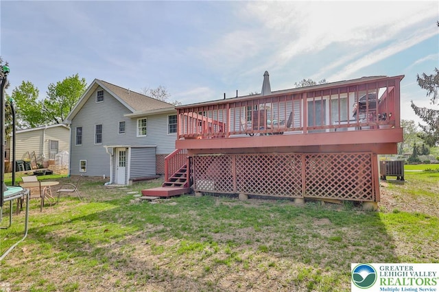 rear view of house with cooling unit, a yard, stairway, and a deck
