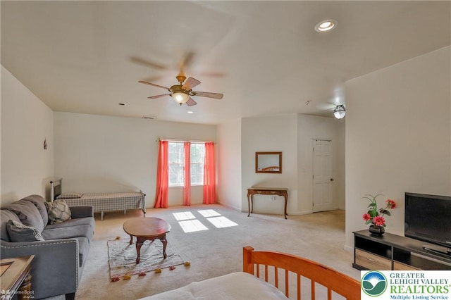 carpeted living room featuring a ceiling fan and recessed lighting