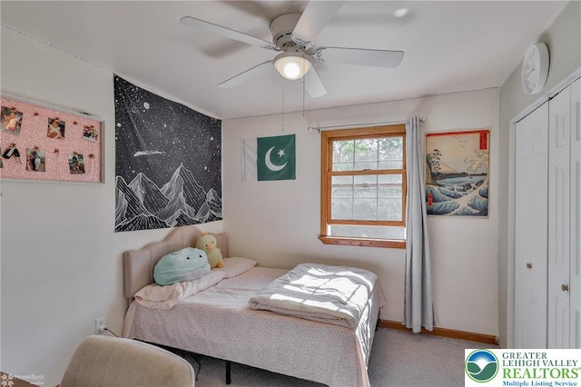 bedroom featuring baseboards, a closet, ceiling fan, and carpet floors