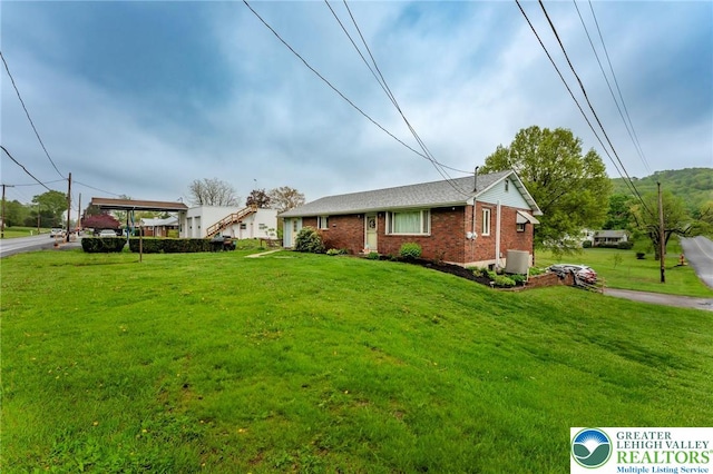 1804 Long Run Rd, Pa, PA 17972 - view of front of home featuring central AC unit, brick siding, and a front yard