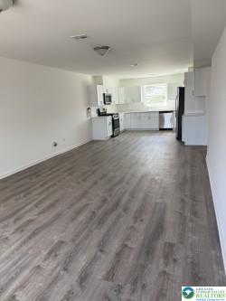 419 W Lincoln, Easton, PA 18042 - unfurnished living room with dark wood finished floors and baseboards