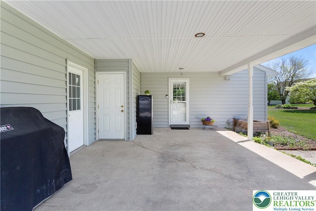 view of patio with area for grilling and an attached carport