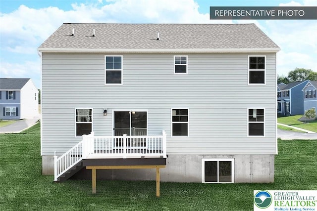 back of property with a wooden deck and a lawn