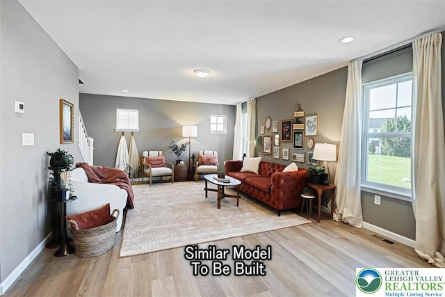 living area featuring baseboards, recessed lighting, visible vents, and wood finished floors