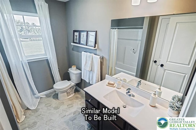 bathroom with baseboards, vanity, toilet, and a shower with shower curtain