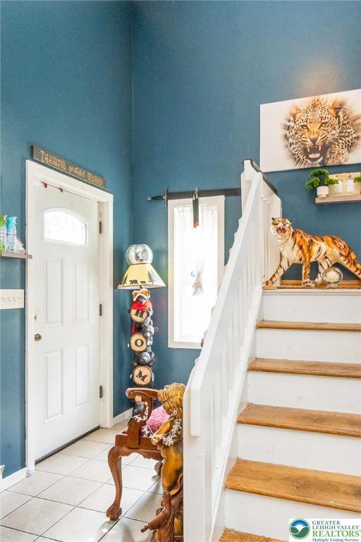 1231 Kensington Dr, Stroud Twp, PA 18301 - tiled foyer entrance featuring stairway and baseboards