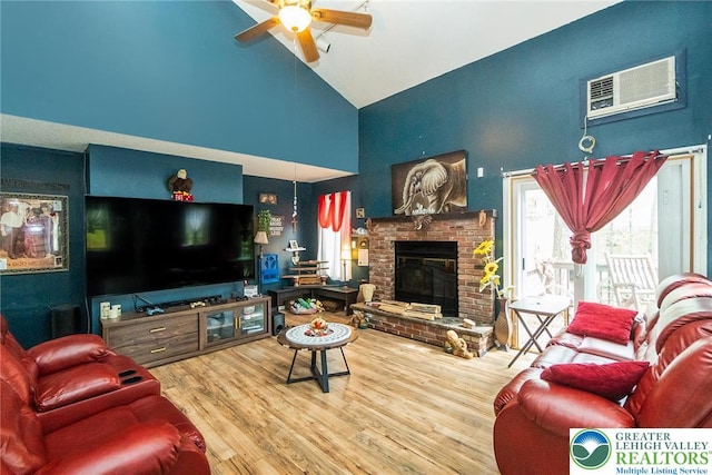 1231 Kensington Dr, Stroud Twp, PA 18301 - living room with wood finished floors, high vaulted ceiling, a wall mounted AC, a brick fireplace, and a ceiling fan