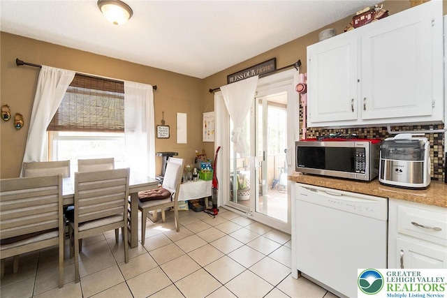 1231 Kensington Dr, Stroud Twp, PA 18301 - kitchen featuring white dishwasher, light countertops, white cabinets, and stainless steel microwave