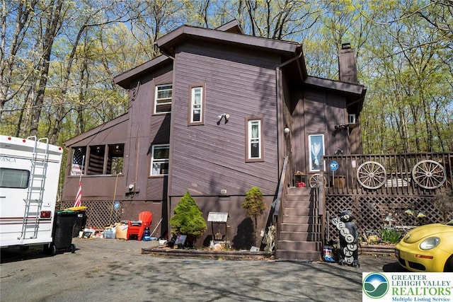 1231 Kensington Dr, Stroud Twp, PA 18301 - view of home's exterior featuring stairway and a chimney