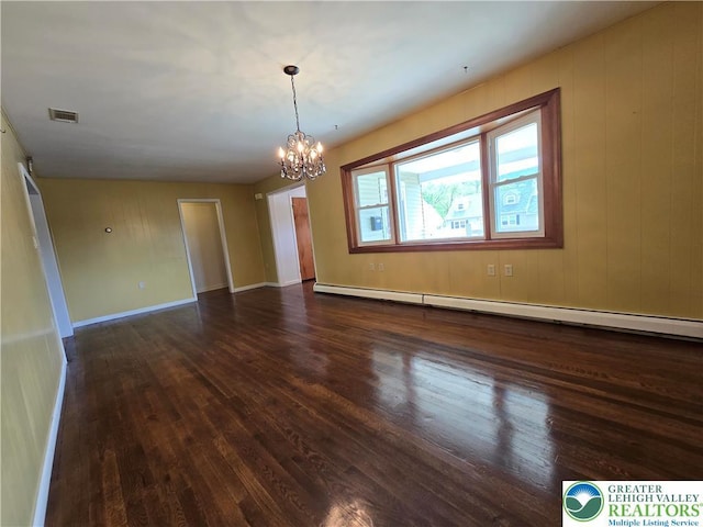 empty room featuring visible vents, baseboards, baseboard heating, a chandelier, and dark wood-style floors