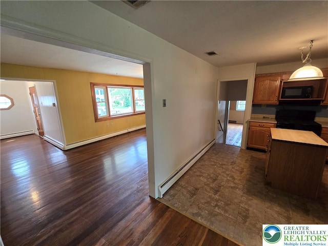 kitchen with baseboards, black appliances, baseboard heating, and visible vents