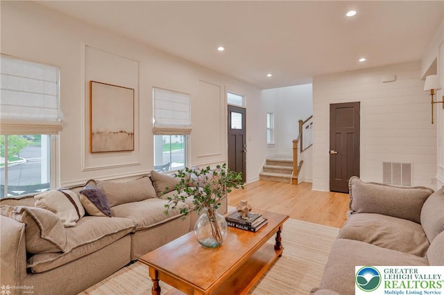 living room with stairs, visible vents, recessed lighting, and plenty of natural light