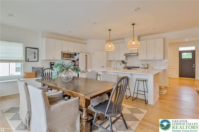 dining area featuring light wood finished floors