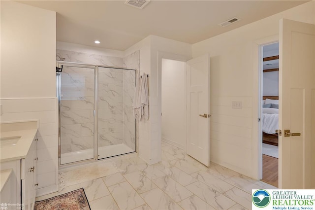 bathroom featuring marble finish floor, a marble finish shower, visible vents, and recessed lighting