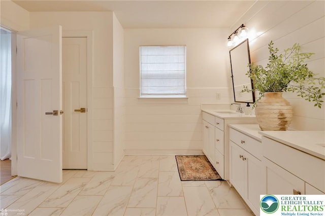 bathroom with marble finish floor and vanity
