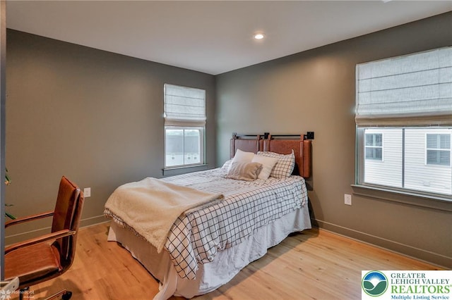 bedroom featuring baseboards, light wood finished floors, and recessed lighting