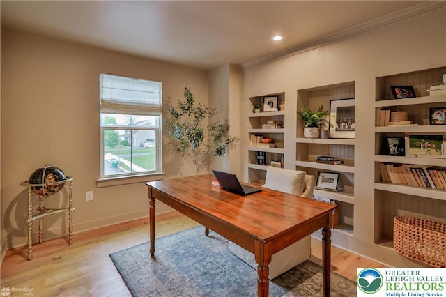 office space with recessed lighting, baseboards, ornamental molding, built in features, and light wood-style floors
