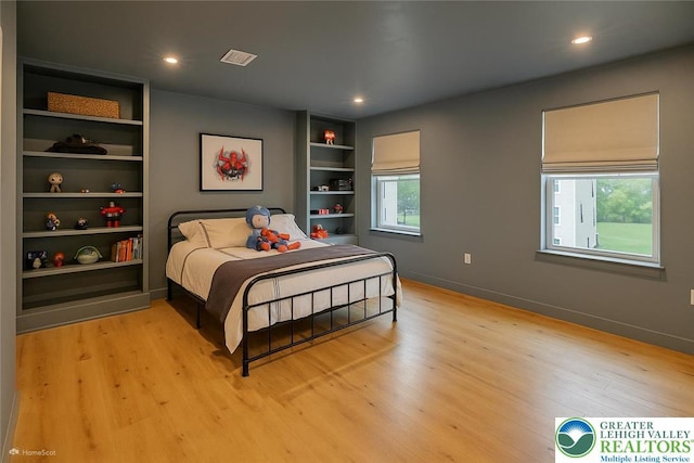 bedroom with light wood-style flooring, visible vents, and recessed lighting