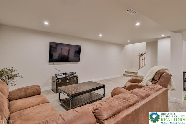 living area with light colored carpet, visible vents, and recessed lighting