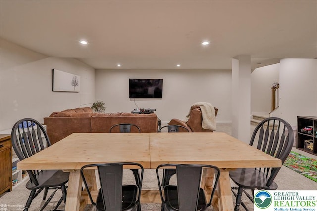dining space featuring light colored carpet and recessed lighting
