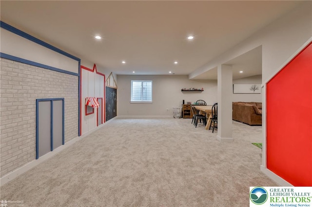 playroom featuring brick wall, carpet floors, and recessed lighting