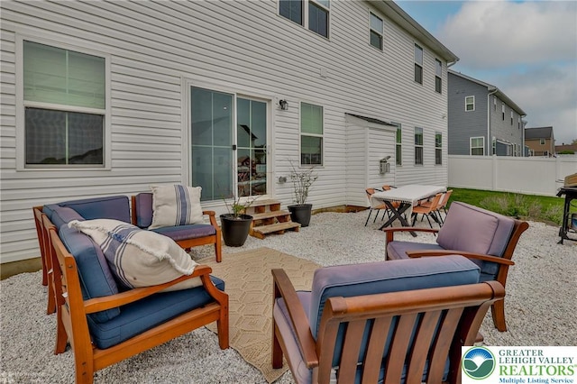 view of patio / terrace featuring an outdoor hangout area, outdoor dining area, and fence