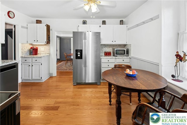 8043 Richlandtown Rd, East Rockhill Twp, PA 18951 - kitchen with appliances with stainless steel finishes, ceiling fan, decorative backsplash, and white cabinetry
