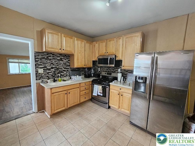 219 N Fountain St, Allentown City, PA 18102 - kitchen featuring appliances with stainless steel finishes, light brown cabinetry, a sink, and light countertops