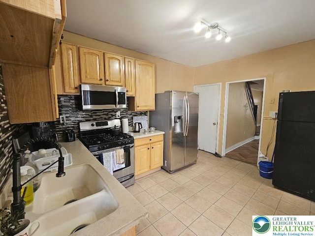 219 N Fountain St, Allentown City, PA 18102 - kitchen featuring stainless steel appliances, a sink, light countertops, backsplash, and light brown cabinets