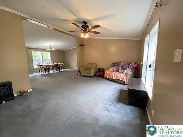 bedroom with ornamental molding, baseboards, a chandelier, a wood stove, and ceiling fan