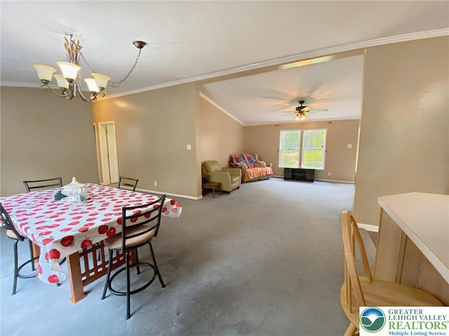 carpeted dining area with baseboards, ornamental molding, a ceiling fan, and a chandelier