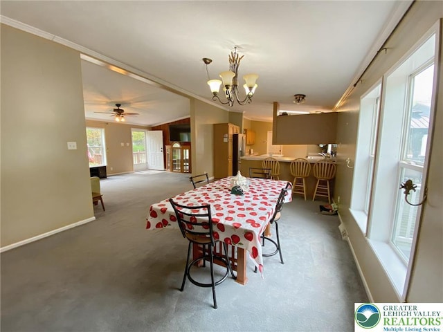 carpeted dining room featuring crown molding, a chandelier, and baseboards