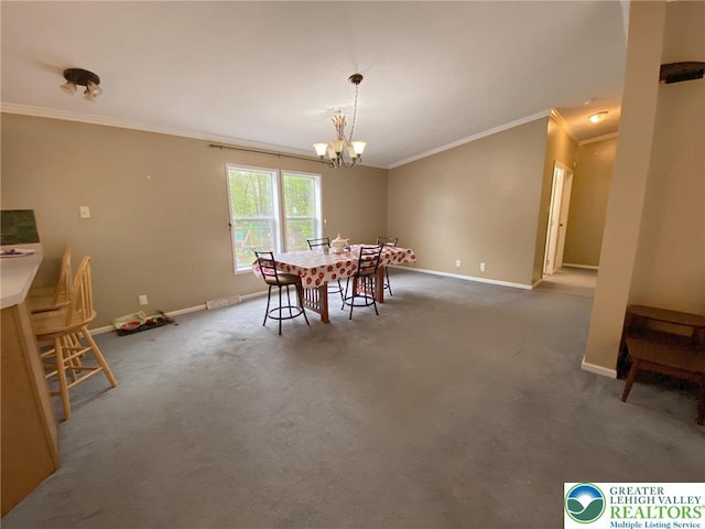carpeted dining room with ornamental molding, baseboards, and a chandelier