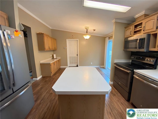 kitchen with appliances with stainless steel finishes, crown molding, dark wood finished floors, a kitchen island, and light countertops