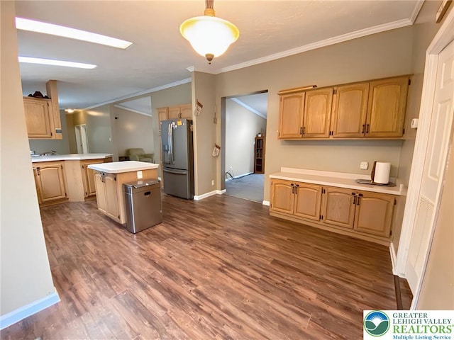 kitchen featuring stainless steel refrigerator with ice dispenser, light countertops, crown molding, a center island, and dark wood-style floors