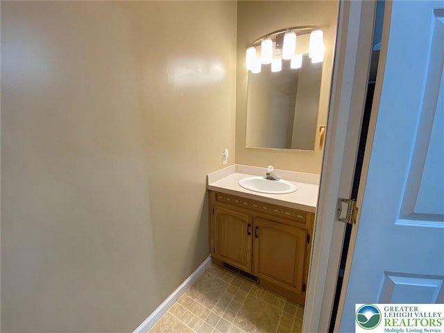 bathroom with vanity and baseboards