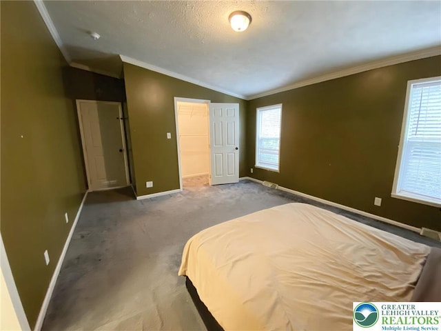 bedroom featuring vaulted ceiling, crown molding, baseboards, multiple windows, and carpet