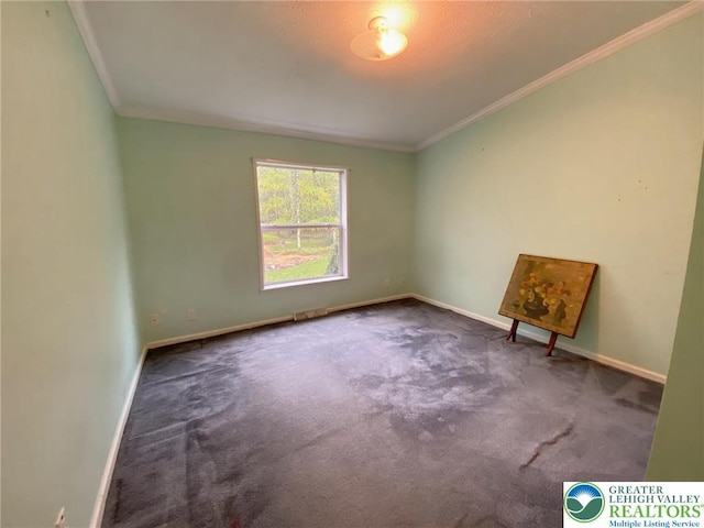 carpeted spare room with ornamental molding and baseboards