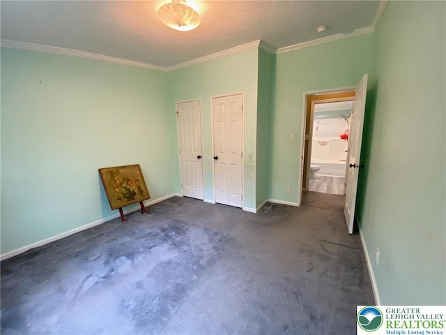 unfurnished bedroom featuring ornamental molding, carpet floors, and baseboards