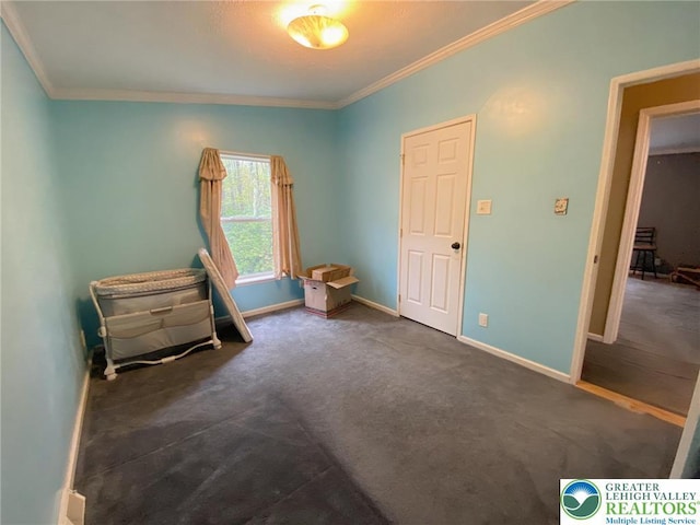 bedroom featuring crown molding, baseboards, and dark carpet