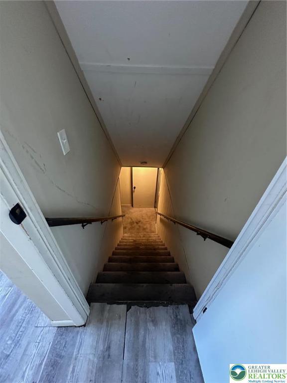 stairway featuring wood finished floors