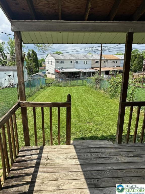 wooden terrace with a residential view