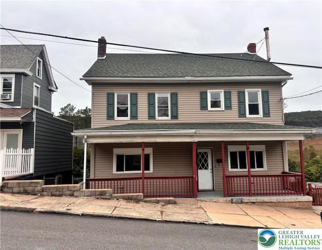 121 E Ridge St, Coaldale Borough, PA 18218 - farmhouse-style home with covered porch and a chimney