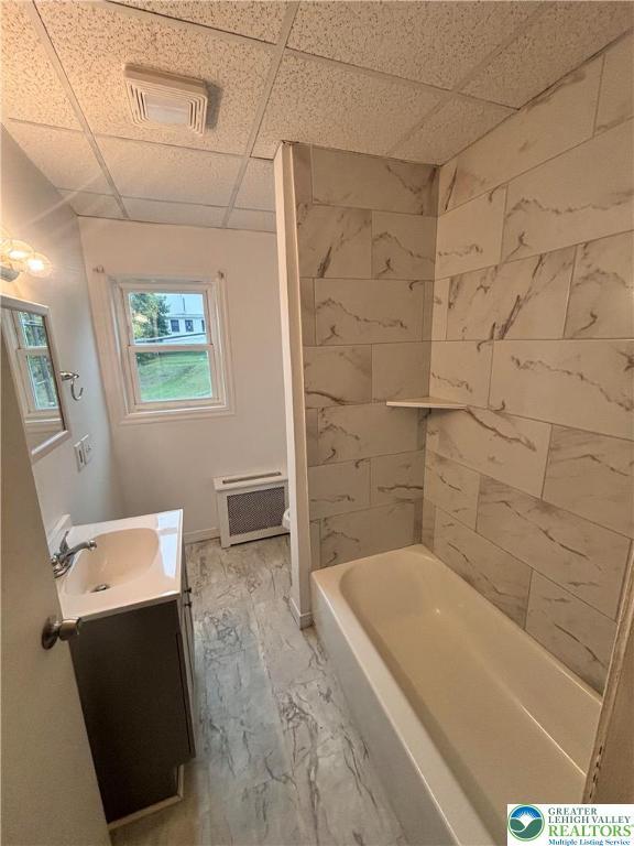 121 E Ridge St, Coaldale Borough, PA 18218 - full bath featuring vanity, a paneled ceiling, marble look tiles, and tub / shower combination