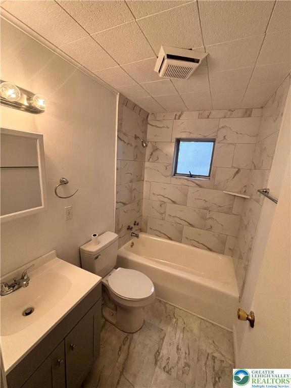 121 E Ridge St, Coaldale Borough, PA 18218 - full bath with marble look tiles, vanity, bathing tub / shower combination, and toilet