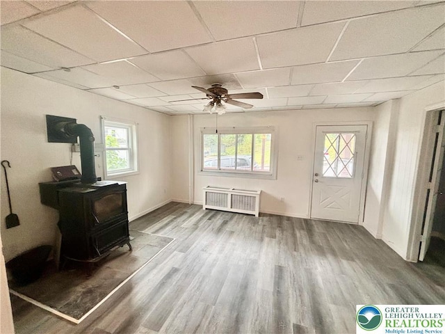 121 E Ridge St, Coaldale Borough, PA 18218 - entrance foyer with a wood stove, radiator, a ceiling fan, wood finished floors, and a paneled ceiling