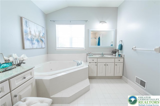bathroom featuring a garden tub, tile patterned floors, vanity, and vaulted ceiling