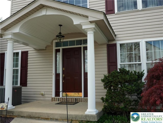 doorway to property featuring central air condition unit and covered porch