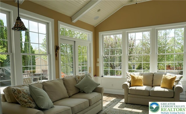 sunroom / solarium featuring wood finished floors and vaulted ceiling