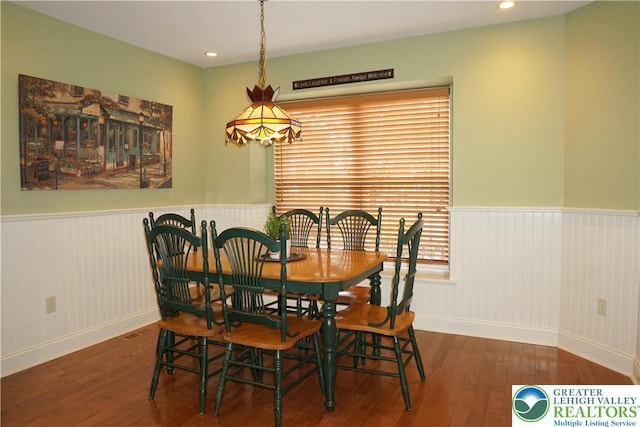 dining room with hardwood / wood-style flooring, wainscoting, baseboards, and recessed lighting